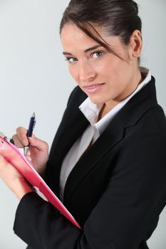 Brunette holding clipboard and pen