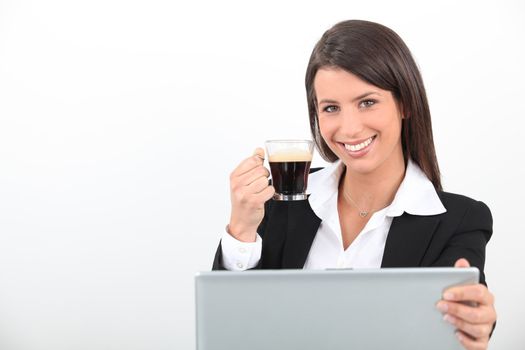 Woman drinking a coffee at her laptop