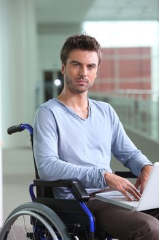 Man on laptop in wheelchair
