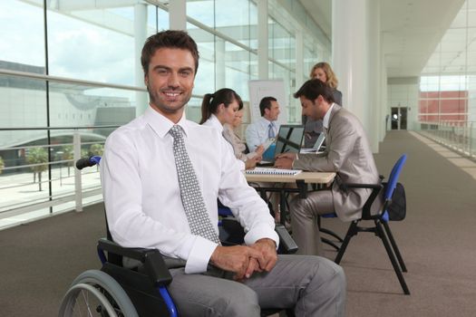 Disabled office worker with colleagues