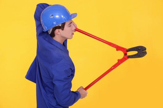 Tradesman holding large clippers