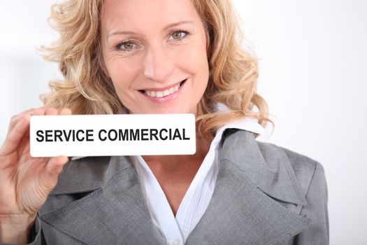 Woman holding Service Commercial sign