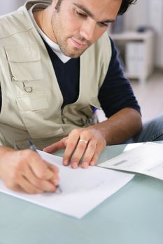 Man writing on a piece of paper