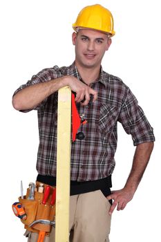 craftsman holding a wooden board