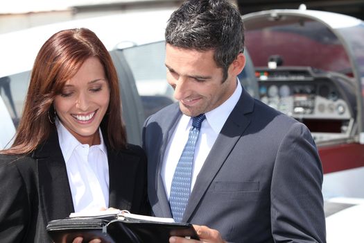 Smiling businesspeople reading notes