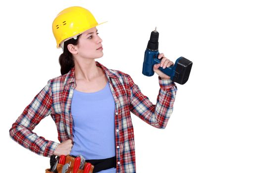 Tradeswoman holding up her electric screwdriver