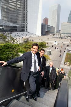 Business people using the escalator