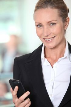 Smiling businesswoman with an office background