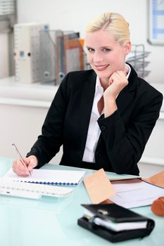 Young woman smiling sitting at a desk