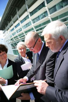 Senior business group meeting outdoors