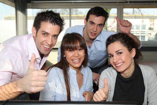 Office workers giving a thumbs up