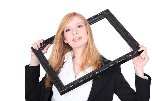 Girl passing her head through a frame