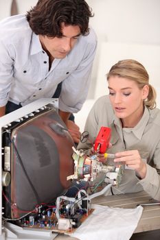 Woman repairing television