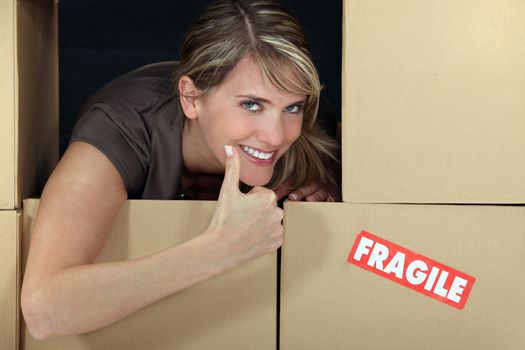 Woman stood amongst fragile boxes