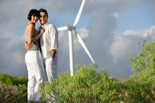 Couple stood by wind farm