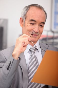 Senior businessman relaxing at desk