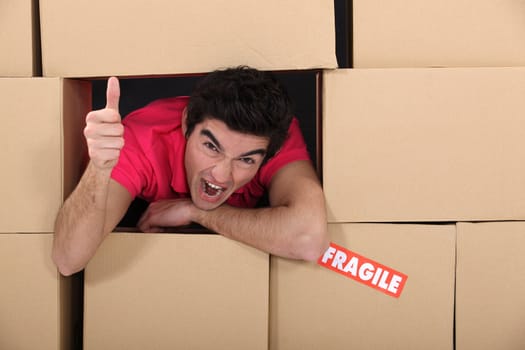 man surrounded by boxes