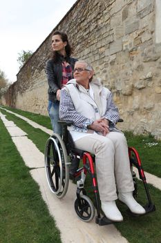 Young woman with elderly woman in wheelchair