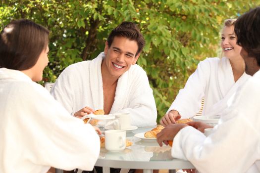 Friends having breakfast together in the garden