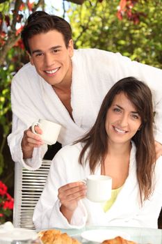 young couple having breakfast outdoors