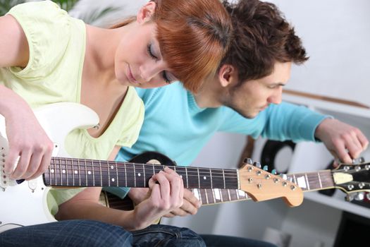 Teenagers playing the guitar