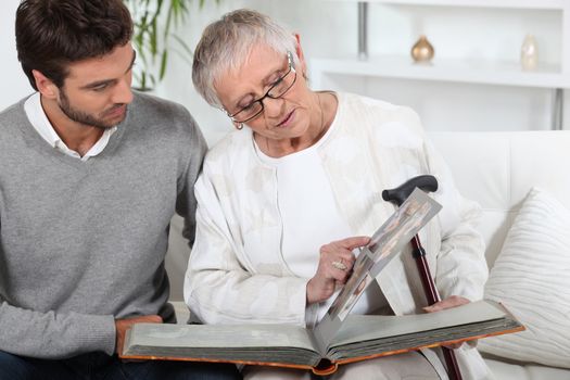 Elderly person looking at photos with son