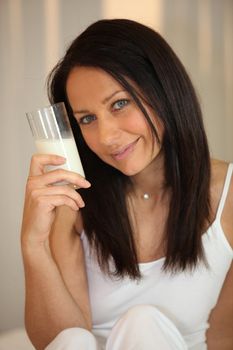 Woman drinking a glass of milk