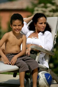 Woman and smiling boy on a deckchair