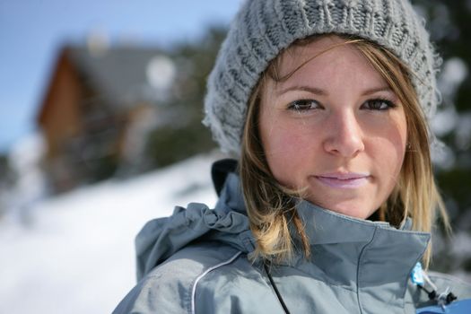 Blond woman stood on snowy mountain