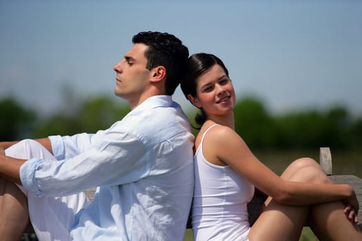 Young couple sitting in the sunshine