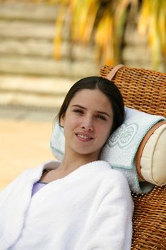 woman in a bathrobe relaxing in a spa center