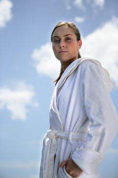 Woman at the beach wearing white robe