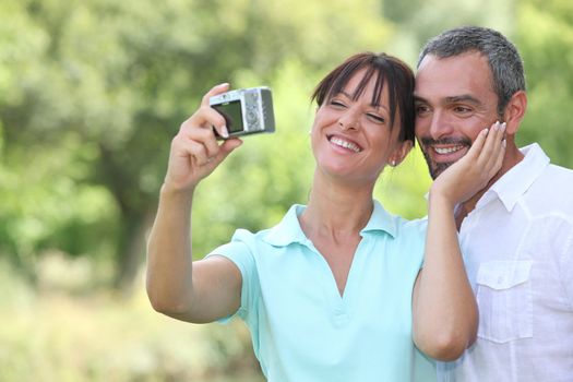 Couple in countryside taking photos