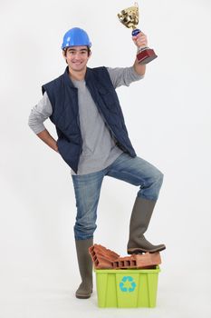 Tradesman holding up a trophy