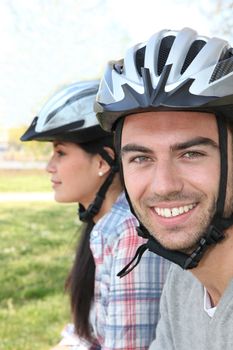 close-up shot of couple of cyclists wearing cycle helmet