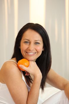 Woman holding an orange