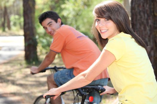 young people biking in the forest