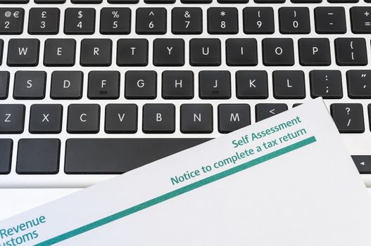Detail of blank tax return form on top of computer keyboard.