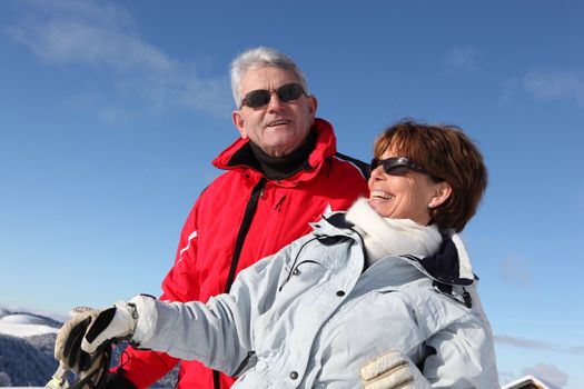 Couple skiing in the mountains