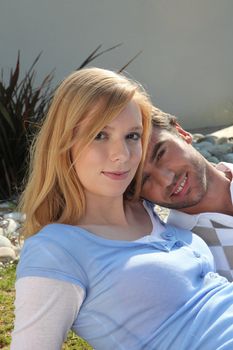 Young couple laid on the grass