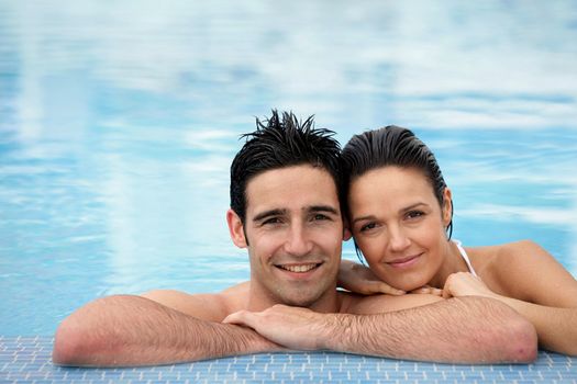 Couple stood together in swimming pool