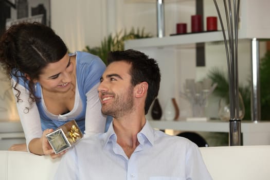 Woman giving gift to boyfriend