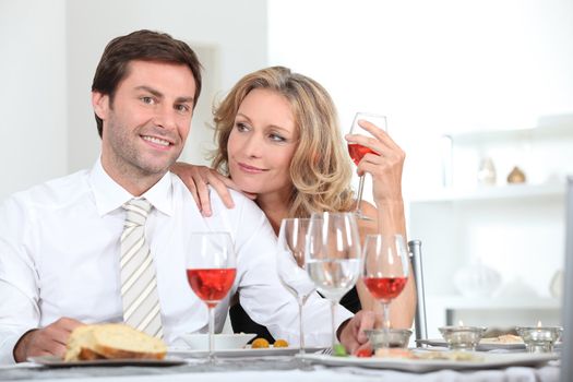 Couple sat at table with wine