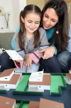 female architect at home with young daughter