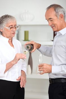 Elderly couple drinking champagne