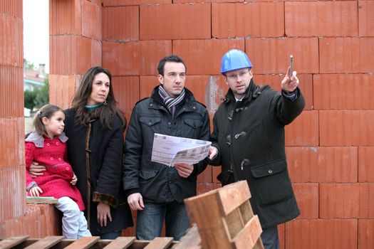 Couple having their new home inspected by an engineer