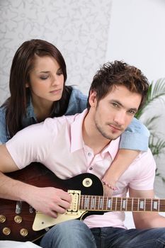 Young woman and young man with guitar