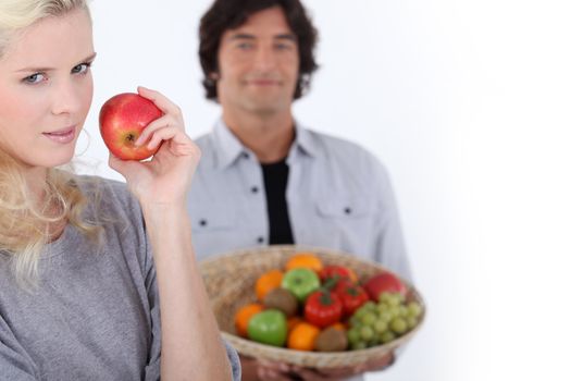 Couple with a basket of fresh produce