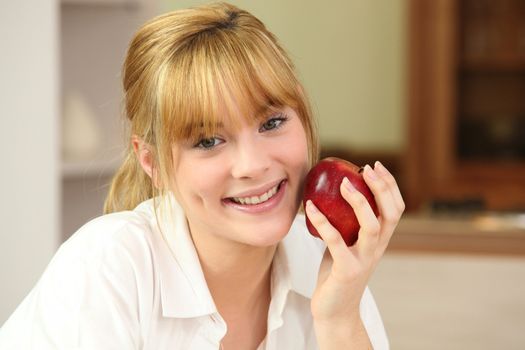 a blonde woman and an apple