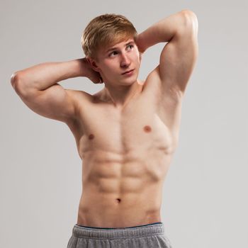 Handsome guy posing with naked torso over background